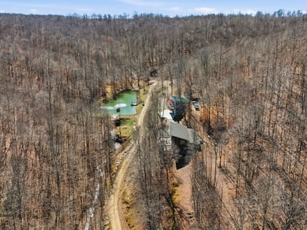 Secluded 25-Acre Retreat with Two Custom Cabins, Spring-Fed Pond & Waterfall