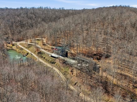 Secluded 25-Acre Retreat with Two Custom Cabins, Spring-Fed Pond & Waterfall