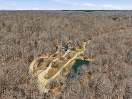 Secluded 25-Acre Retreat with Two Custom Cabins, Spring-Fed Pond & Waterfall