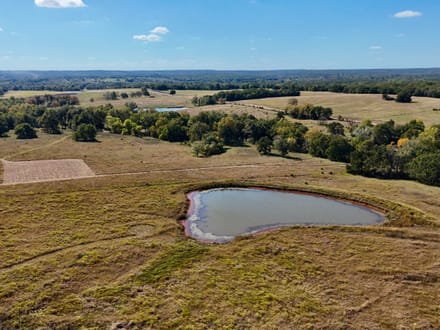 100 Acres | Land with Home for Sale McLoud OK — Five Ponds, Two Water Wells, Multiple Shops, Adjoining Acreage 