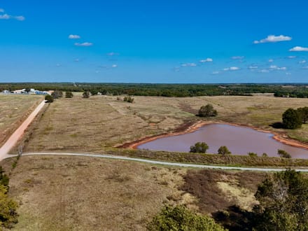 100 Acres | Land with Home for Sale McLoud OK — Five Ponds, Two Water Wells, Multiple Shops, Adjoining Acreage 
